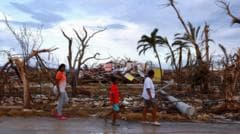 How do hurricanes and typhoons form and is climate change making them stronger?