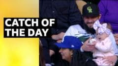 Watch: Fan catches baseball while holding baby